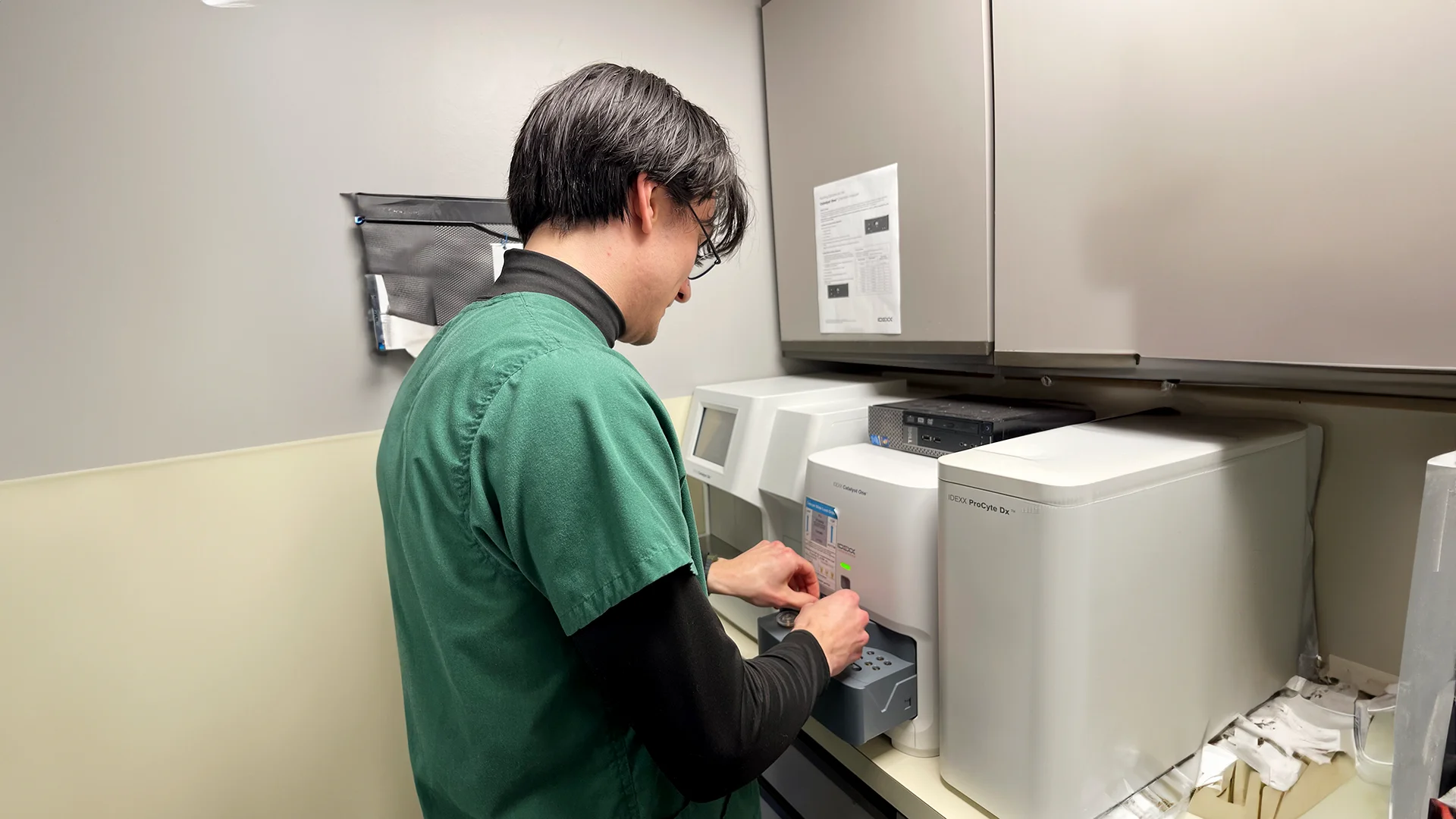 A veterinarian operates diagnostic equipment.